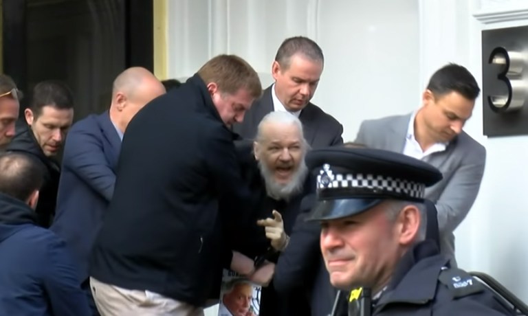 WikiLeaks founder Julian Assange is seen in a prison van traveling to Westminster Magistrates Court in London, Friday, Dec. 20, 2019. Assange is expected to appear in person before Westminster Magistrates in a private hearing related to a Spanish criminal case about alleged surveillance at the Ecuador embassy.