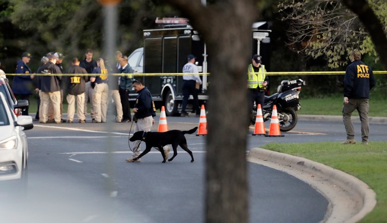 Officials work and stage near the site of Sunday's explosion, Monday, March 19, 2018, in Austin, Texas. Police warned nearby residents to remain indoors overnight as investigators looked for possible links to other deadly package bombings elsewhere in the city this month.