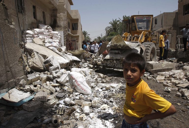 Civilians inspect the scene of a car bomb attack at al-Ameen neighborhood in Baghdad, Iraq, Saturday, June 8, 2013. Iraqi authorities say the car bomb explosion has killed and wounded people in a commercial street in the Shiite neighborhood of al-Ameen, southeastern Baghdad. Several shops were damaged in the attack. (AP Photo/Karim Kadim)