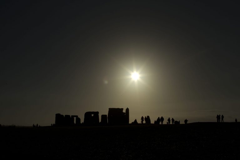   People are silhouetted as the sun rises above the ancient stone circle of Stonehenge, in southern England, as access to the site is given to druids, New Age followers and members of the public on the annual Winter Solstice, Friday, Dec. 21, 2012. Doomsday hour is here and so still are we. According to legend, the ancient Mayans' long-count calendar ends at midnight Thursday, ushering in the end of the world. Didn't happen. 