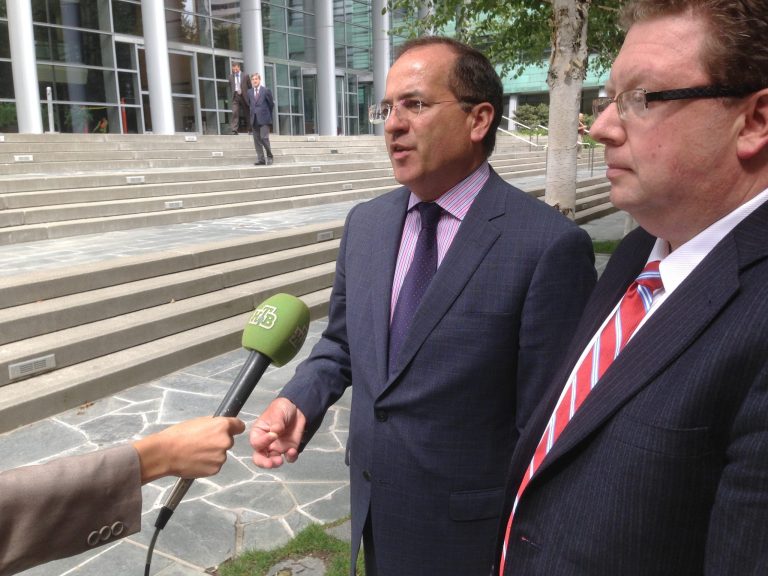 Robert W. Ray, left, and Ely Goldin, right, attorneys for Roman Seleznev, speak with reporters outside the U.S. District Courthouse in Seattle on Friday, Aug. 15, 2014. Seleznev, the 30-year-old son of a prominent Russian lawmaker, was ordered to remain in custody pending his trial on charges that he hacked into online cash register systems to steal hundreds of thousands of credit card numbers, then sold those credit card numbers online. He was arrested last month in the Maldives and transferred to Seattle to face charges. (AP Photo/Gene Johnson)