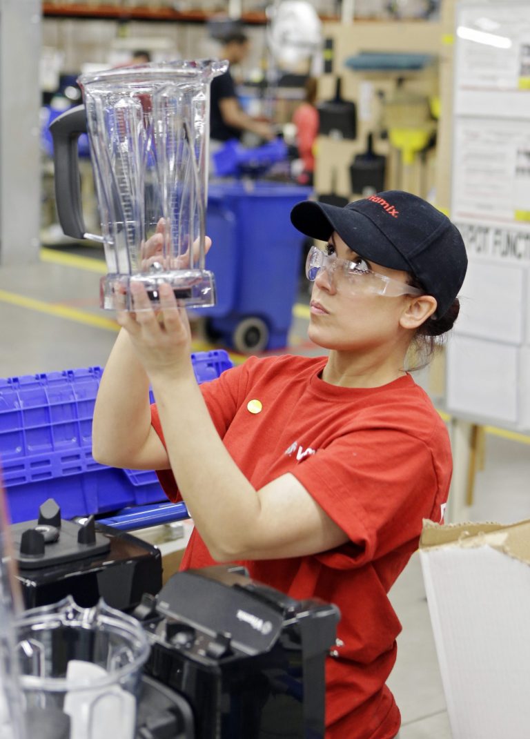 In this Tuesday, April 15, 2014 photo, Glendy Vega inspects a blender container before final packaging at the Vitamix  manufacturing facility in Strongsville, Ohio. The Labor Department reports, on Tuesday, Sept. 16, 2014, on U.S. producer price inflation in August. The report measures price changes before they reach consumers. (AP Photo/Mark Duncan)