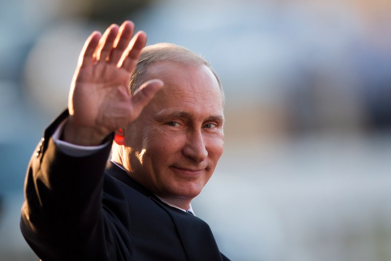 Russia's President Vladimir Putin waves to photographers as he leaves the Itamaraty Palace after attending the final day of the BRICS Summit in Brasilia, Brazil, Wednesday. (AP Photo/Felipe Dana)