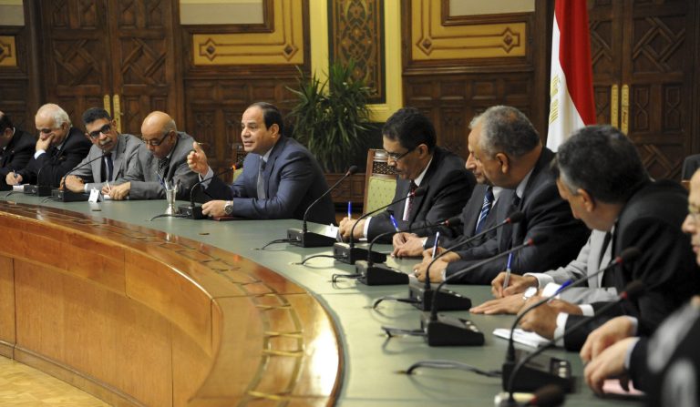 In this photo provided by Egypt's state news agency MENA, Egyptian President Abdel-Fattah el-Sissi, center, meets with editors of Egyptian newspapers and media in the presidential palace, in Cairo Egypt, Sunday, Aug. 24, 2014. El-Sissi denied Sunday any military involvement in neighboring Libya, a day after Islamist militias accused Cairo of bombing their posts in Tripoli, Egypt's state news agency reported. El-Sissi said Egypt is in consultation with Libya's neighbors to find a political solution to the violent power struggle between rival groups. (AP Photo/MENA)