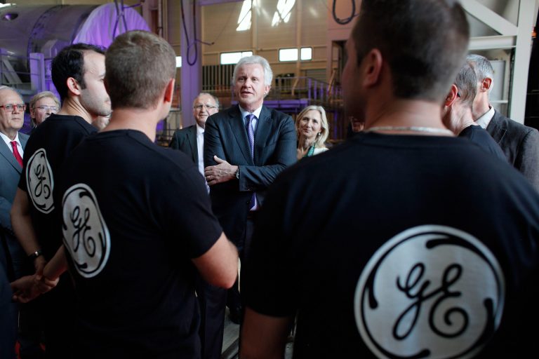 FILE - In this June 24, 2014 file photo, General Electric Co. CEO Jeffrey R. Immelt, center, speaks with workers as he visits the General Electric plant in Belfort, eastern France. General Electric Co. releases quarterly earnings before the market opens on Friday, Oct. 17, 2014. (AP Photo/Thibault Camus, File)