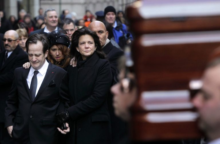   FILE - In this Thursday, Jan. 5, 2012 file photo, Matthew Badger, left, and Madonna Badger, parents of three children who were killed in a Christmas Day fire, react as one of the caskets is carried into a church during the funeral in New York. Criminal charges won't be filed in the Christmas morning house fire that killed three girls and their grandparents, Stamford State's Attorney David Cohen said Friday June 8, 2012. (AP Photo/Seth Wenig, file)  