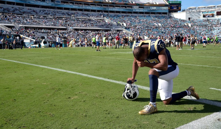 Los Angeles Rams wide receiver Robert Woods kneels in the end zone in prayer before an NFL football game against the Jacksonville Jaguars. The National Football League will not punish players for kneeling during the national anthem, NFL Commissioner Roger Goodell said Tuesday. (AP Photo/Phelan M. Ebenhack)