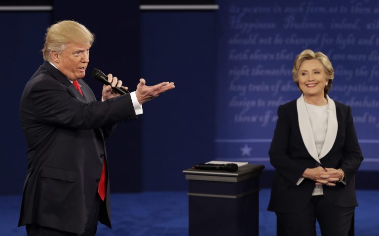 Republican presidential nominee Donald Trump speaks with Democratic presidential nominee Hillary Clinton during the second presidential debate at Washington University in St. Louis, Sunday, Oct. 9, 2016. (AP Photo/John Locher)