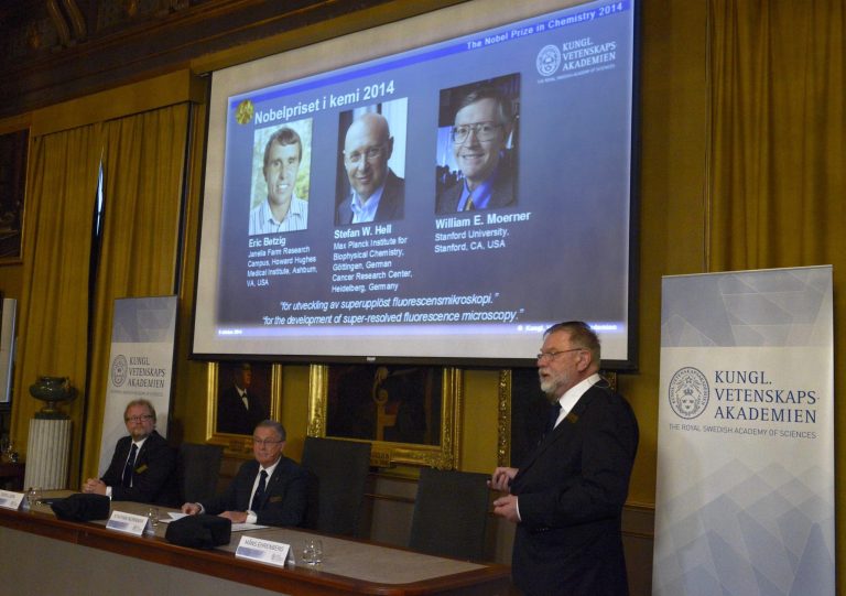 Professor Mans Ehrenberg, right speaks during the presentation of the Nobel Chemistry laureates 2014 at the  Royal Academy of Sciences  Wednesday Oct. 8, 2014 . Americans Eric Betzig and William Moerner and German scientist Stefan Hell  won the Nobel Prize in Chemistry for 