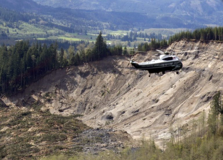 Marine One helicopter, carrying President Barack Obama, takes an aerial tour of Oso, Wash., Tuesday, April 22, 2014, above the site of the deadly mudslide that struck the community in March. (AP Photo/Carolyn Kaster)