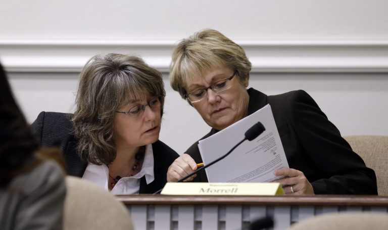 This Feb. 20, 2013 photo, Rep. Dawn Morrell, D-Puyallup, right, and Rep. Gael Tarleton, D-Seattle, talk during a committee hearing in Olympia, Wash. Workers in Washington could be the first in the country to be guaranteed paid vacation time under legislation being considered by state lawmakers.  Tarleton of Seattle, the prime sponsor of House Bill 2238, said the measure would require public and private employers with 25 or more employees to provide vacation leave for those who work 20 hours or more per week. (AP Photo/Elaine Thompson)