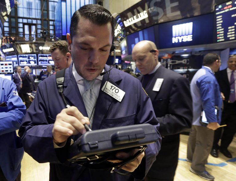 Trader Michael Zicchinolfi, foreground, works on the floor of the New York Stock Exchange Tuesday, Oct. 14, 2014. U.S. stocks rose moderately in early trading Tuesday as investors pored over corporate earnings reports.  (AP Photo/Richard Drew)