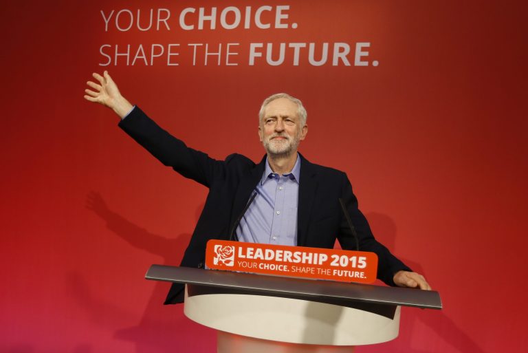 Jeremy Corbyn waves on stage after he is announced as the new leader of The Labour Party during the Labour Party Leadership Conference in London, Saturday, Sept. 12, 2015. Corbyn will now lead Britain's main opposition party. (AP Photo/Kirsty Wigglesworth)