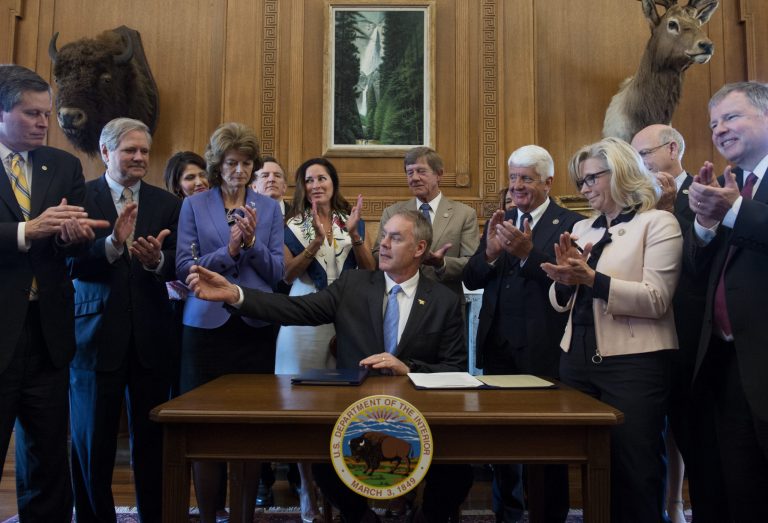 Interior Secretary Ryan Zinke, accompanied by Republican members of Congress, signs an order lifting a moratorium on new coal leases on federal lands and a related order on coal royalties with, Wednesday, March 29, 2017, at the Interior Department in Washington. From left are, Sen. Steve Daines, R-Mont., Sen. John Hoeven, R-N.D., Sen. Lisa Murkowski, R-Alaska, Zinke's wife Lolita, Rep. Scott Tipton, R-Colo., Rep. Rob Bishop, R-Utah and Rep. Liz Cheney, R-Wyo. (AP Photo/Molly Riley)