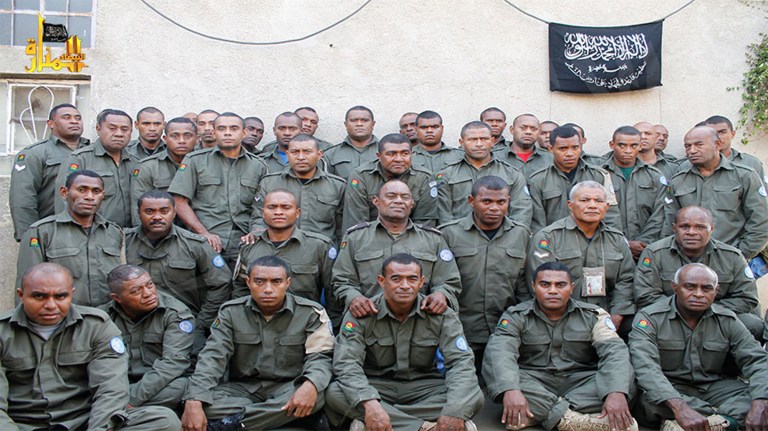 This undated image attached in a statement released on Saturday, Aug. 30, 2014 on the Hanin Network website, a militant website, shows Fijian UN peacekeepers who were seized by The Nusra Front on Thursday in the Golan Heights in the buffer zone between Syria and Israel. Al-Qaida-linked Syrian rebels holding 45 Fijian peacekeepers hostage have issued a set of demands for their release, including the extremist group's removal from a U.N. terrorist list and compensation for the killing of three of its fighters in a shootout with international troops, an official said Tuesday. (AP Photo/Hanin Network Website)