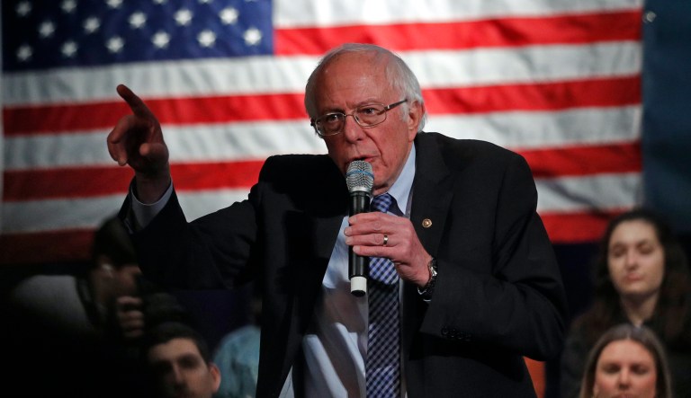 Democratic presidential candidate Sen. Bernie Sanders, I-Vt., speaks at the J Street National Conference, with the hosts of "Pod Save the World," Tommy Vietor, left, and Ben Rhodes, Monday, Oct. 28, 2019, in Washington.