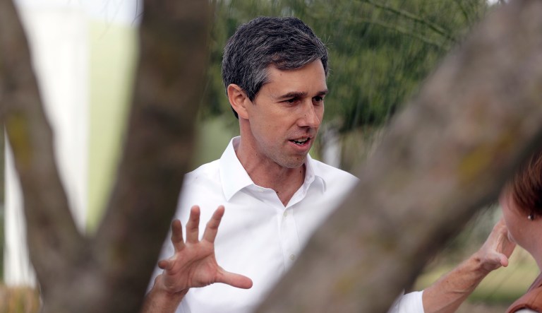 In this Saturday, Jan. 6, 2018, photo, Texas Democratic Rep. Beto O'Rourke talks to a woman during a visit to the National Butterfly Center in Mission, Texas, a possible location for a border wall.