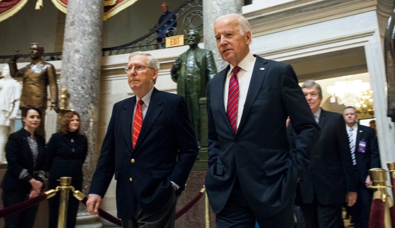 Senate Majority Leader Mitch McConnell (R-Ky.), left, and Vice President Joe Biden, walk through Statuary Hall on their way to a joint session of Congress to count the votes in Washington, Friday, Jan. 6, 2017. It's official: Congress has tallied the Electoral College votes and Donald Trump has been elected president.