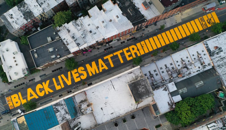 A Black Lives Matter slogan is painted in orange on Fulton Street, Monday, June 15, 2020, in the Brooklyn borough of New York.