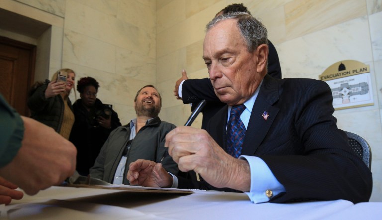Former New York City Mayor Michael Bloomberg fills out paperwork, Tuesday, Nov. 12, 2019, at the state Capitol in Little Rock, Ark., to appear on the ballot in Arkansas' March 3 presidential primary. Bloomberg hasn't formally announced a bid for the Democratic presidential nomination, but his trip to Arkansas is the latest indication that he is leaning toward a run.