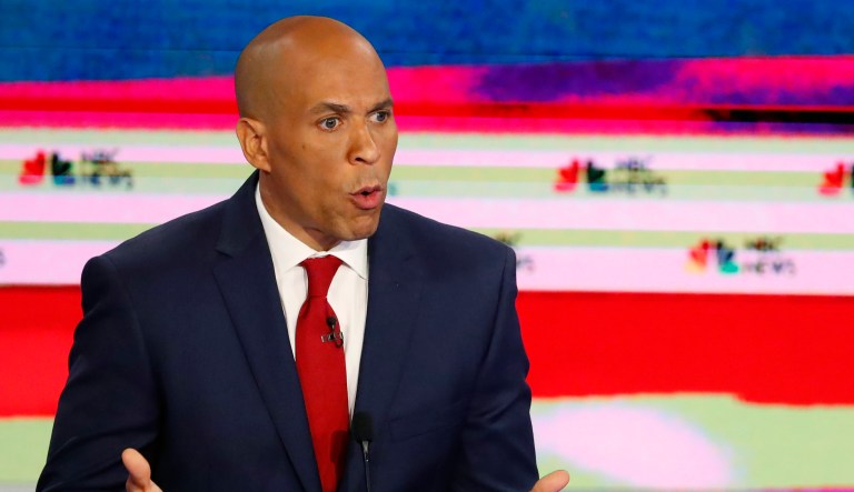 Democratic presidential candidate Sen. Cory Booker, D-N.J., speaks during a Democratic primary debate hosted by NBC News at the Adrienne Arsht Center for the Performing Art, Wednesday, June 26, 2019, in Miami, as Sen. Elizabeth Warren, D-Mass., listens.