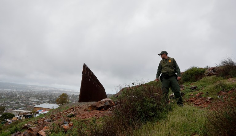 Border Patrol agent Vincent Pirro looks on near where a border wall ends that separates the cities of Tijuana, Mexico, and San Diego, Tuesday, Feb. 5, 2019, in San Diego.