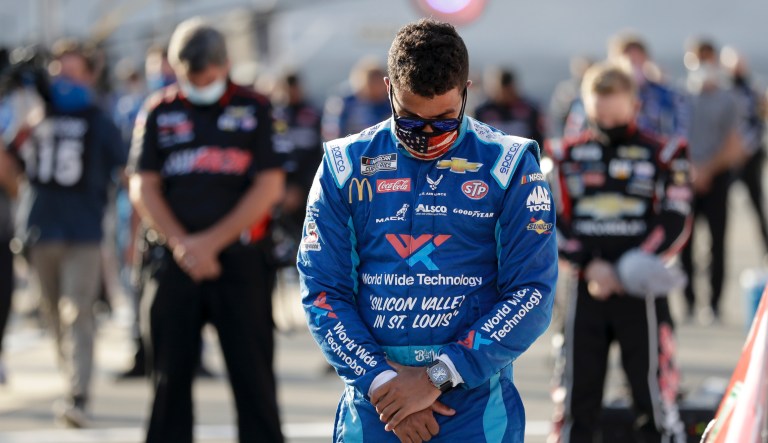 Bubba Wallace (43) bows his head during a prayer before a NASCAR All-Star Open auto race at Bristol Motor Speedway in Bristol, Tenn, Wednesday, July 15, 2020.