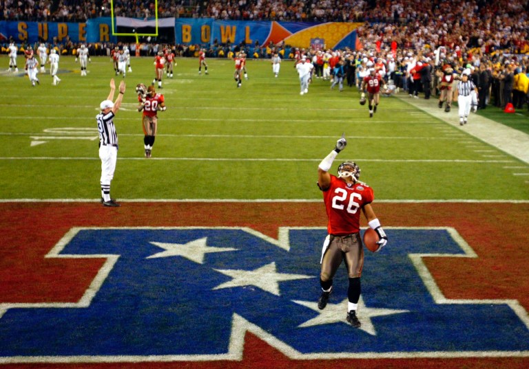 FILE - In this Jan. 26, 2003, file photo, Tampa Bay Buccaneers cornerback Dwight Smith (26) celebrates his 50-yard interception return for a touchdown to cap the Buccaneers' 48-21 win over the Oakland Raiders in NFL football's Super Bowl XXXVII in San Diego. In the 48 year history of the Super Bowl, 2014 is only the second time the No. 1 team in total yards and total passing offense, Denver, has faced the No. 1 defensive team in total yards and passing yards given up: Seattle. The only other time this happened, in 2003, defensive titan Tampa Bay swamped offensive powerhouse Oakland. (AP Photo/Lawrence Jackson, File)