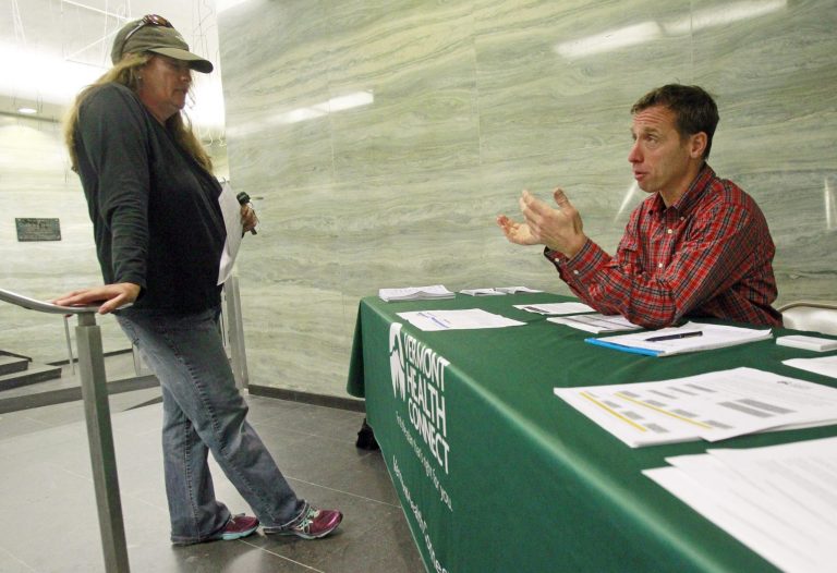 A navigator for Vermont Health Connect answers questions about health insurance options on Oct. 1 in Montpelier, Vt. (AP Photo/Toby Talbot)