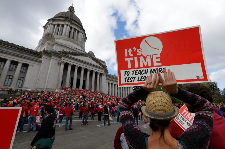 Hundreds of Washington state teachers and other supporters on the steps of the Legislative Building, Saturday, April 25, 2015 at a Washington Education Association rally at the Capitol in Olympia, Wash. (AP Photo/Ted S. Warren)