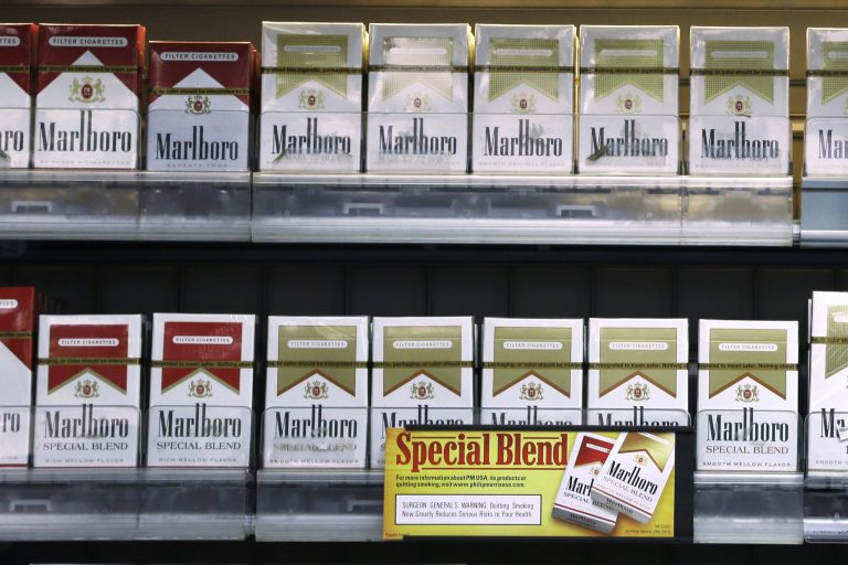 FILE - In this Wednesday, Oct. 23, 2013, file photo, Marlboro Gold and other Marlboro varieties of cigarettes are displayed in a Little Rock, Ark., store. Altria Group reports quarterly earnings on Thursday, Jan. 30, 2014. (AP Photo/Danny Johnston)