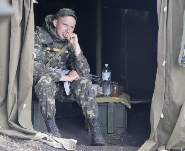 A Ukrainian soldier take a rest at a checkpoint outside Slovyansk, Ukraine, Friday, May 30, 2014.The Ukrainian Acting Defence Minister said on Friday that troops had ousted separatists from southern and western parts of the Donetsk region and north of the Luhansk region. (AP Photo/Efrem Lukatsky)