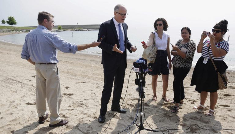 In this Aug. 4, 2014 photo, Paul Vallas, the Democratic candidate for Illinois lieutenant governor, speaks at a news conference on the shore of Lake Michigan in Chicago. The candidates for Illinois lieutenant governor don't just differ on policy issues, the Democratic former school executive and Republican councilwoman are playing starkly contrasting roles on the campaign trail. Gov. Pat Quinn's pick Vallas recently has taken to Chicago events to criticize Republican Bruce Rauner's ideas and business record. while, Rauner's running mate Evelyn Sanguinetti, tends to appear alongside the businessman, emphasizing her life story as the child of immigrants. (AP Photo/M. Spencer Green)