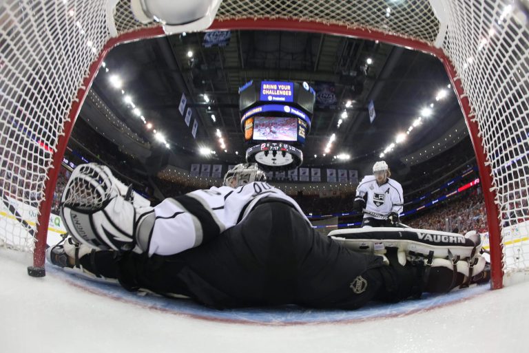   A puck shot by New Jersey Devils' Zach Parise, blocked from view gets past Los Angeles Kings goalie Jonathan Quick (32) during the first period of Game 5 of the NHL hockey Stanley Cup finals Saturday, June 9, 2012, in Newark N.J. (AP Photo/Bruce Bennett, Pool)  