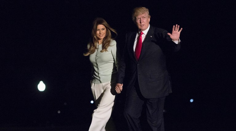 President Donald Trump and first lady Melania Trump walk from Marine One across the South Lawn to White House as they return from Sigonella, Italy. (AP Photo/Carolyn Kaster)