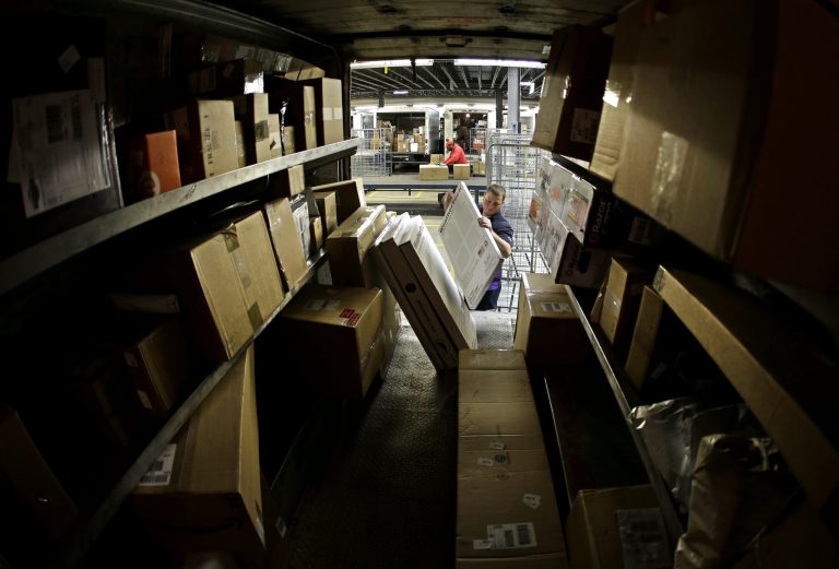 FILE - In this Monday, Dec. 16, 2013, file photo, driver Kyle Woodroof loads packages in his delivery truck in Kansas City, Mo. The Commerce Department reports on U.S. factory orders in December on Tuesday, Feb. 4, 2014. (AP Photo/Charlie Riedel, File)