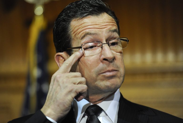   Connecticut Gov. Dannel P. Malloy wipes away a tear as he recalls how and why he decided to tell the families of the Sandy Hook Elementary School shooting that their loved ones were dead during a news conference at the Capitol in Hartford, Conn., Monday, Dec. 17, 2012. (AP Photo/Jessica Hill)  