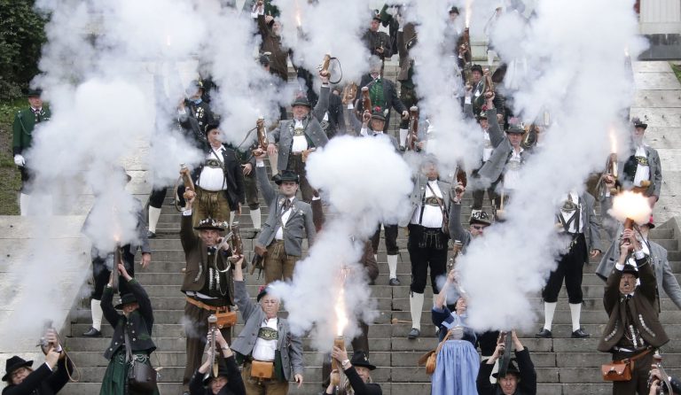 Bavarian riflemen and women in traditional costumes fire their muzzle loaders in front of the 'Bavaria' statue on the last day of the Oktoberfest beer festival in Munich, southern Germany, Sunday, Oct. 5, 2014. (AP Photo/Matthias Schrader)