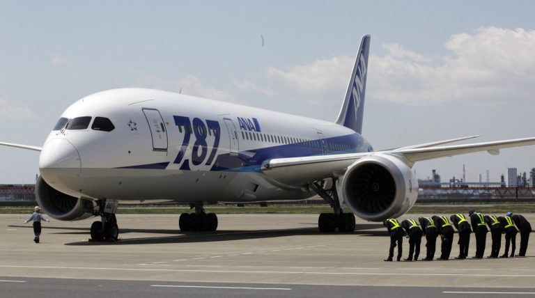 FILE - In this April 28, 2013 file photo, ground crewmen bow after a Boeing 787 Dreamliner of All Nippon Airways lands after a test flight at Haneda International Airport in Tokyo. ANA is ordering 70 aircraft with a list price of 1.7 trillion yen ($17 billion) from Boeing Co. and Airbus, in the largest order in the Japanese carrier's history. The orders made on Thursday, March 27, 2014 underline ANA's ambition to become one of the world's leading airlines as well as Japan's tourism drive leading up to the 2020 Tokyo Olympics. The country is aiming to boost overseas visitors to 20 million a year. (AP Photo/Shizuo Kambayashi, File)