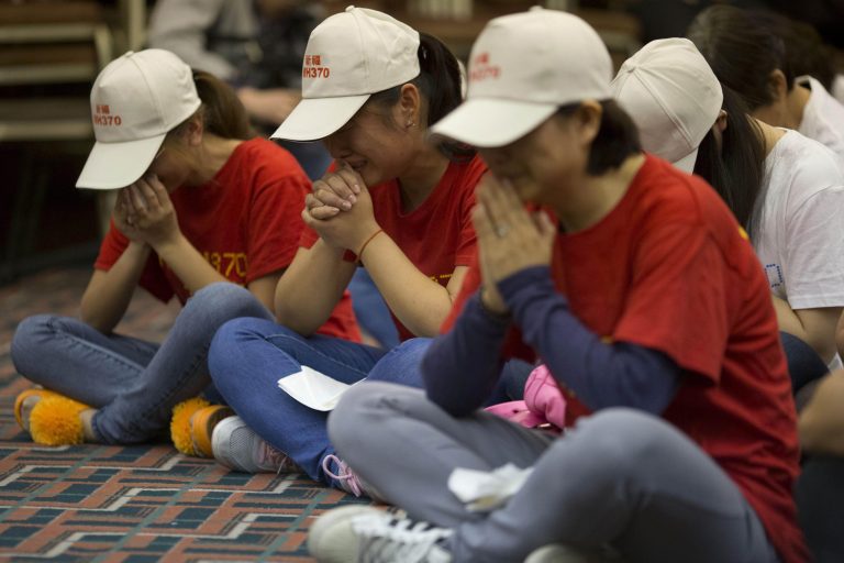 Relatives of Chinese passengers on board the Malaysia Airlines Flight 370 pray at a hotel conference room in Beijing, China, Friday, April 18, 2014. A robotic submarine headed back down into the depths of the Indian Ocean on Friday to scour the seafloor for any trace of the missing Malaysian jet one month after the search began off Australia's west coast, as data from the sub's previous missions turned up no evidence of the plane.(AP Photo/Ng Han Guan)