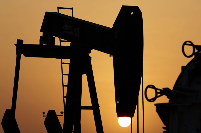 FILE - In this Aug. 3, 2014 file photo, an oil pump works at sunset in the desert oil fields of Sakhir, Bahrain. Political turmoil and military conflict in certain global hotspots has typically sent oil prices soaring. There's plenty of that now, but oil is near its low for the year. (AP Photo/Hasan Jamali, File)