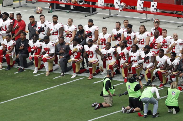 Members of the San Francisco 49ers kneel during the national anthem as others stand prior to an NFL football game against the Arizona Cardinals, Sunday, Oct. 1, 2017, in Glendale, Ariz. (AP Photo/Matt York)