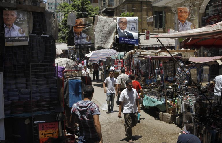   Campaign posters supporting Egyptian presidential candidate Ahmed Shafiq, the last prime minister of deposed president Hosni Mubarak, hang above a popular market in Cairo, Egypt, Tuesday, June 12, 2012. Arabic on the banners reads: 