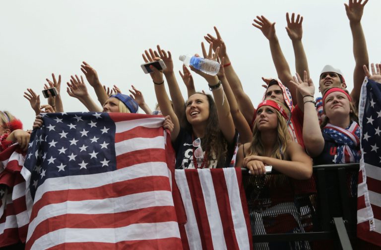 Fans cheer for the United States as they watch a Brazil 2014 World Cup soccer match between the U.S. and Germany at Grant Park in Chicago, Thursday, June 26, 2014. (AP Photo/Stacy Thacker)