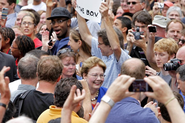   University of Virginia President Teresa Sullivan smiles as she makes her way through the crowd to meet with the UVA Board of Visitors Monday, June 18, 2012 in Charlottesville, Va. University of Virginia faculty leaders on Monday demanded the reinstatement of the schoolâs president and the resignation of two officials involved in her ouster. Officials gave no sign of complying, but acknowledged they could have handled Teresa Sullivanâs abrupt departure better. (AP Photo/Richmond Times-Dispatch, Mark Gormus)  