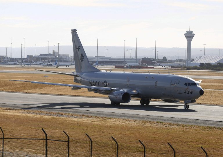 A U.S Navy P-8 Poseidon prepares to takes off from Perth International Airport en route to rejoin the ongoing search operations for missing Malaysia Airlines Flight 370, in Perth, Australia, Friday, April 18, 2014. Investigators were analyzing data collected by a robotic submarine that completed its first successful scan of the seabed Thursday in the hunt for the missing Malaysian plane, but say tests have ruled out that a nearby oil slick came from the aircraft. (AP Photo/Theron Kirkman)