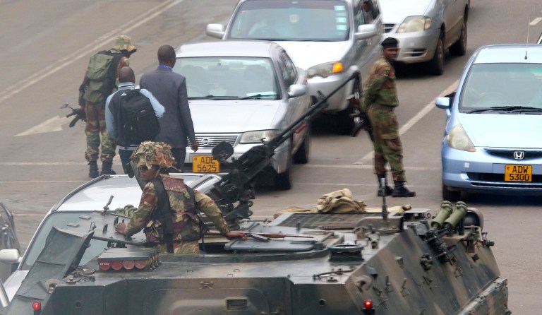 Armed soldiers patrol a street in Harare, Zimbabwe, Wednesday, Nov. 15, 2017. Zimbabwe's army said Wednesday it has President Robert Mugabe and his wife in custody and is securing government offices and patrolling the capital's streets following a night of unrest that included a military takeover of the state broadcaster. (AP Photo)