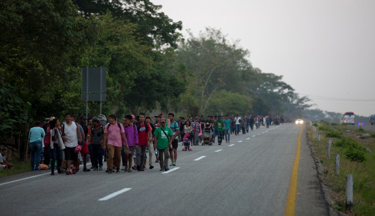 Central American migrants traveling in a caravan to the U.S. border walk on a road in Pijijiapan, Mexico, Monday, April 22, 2019.