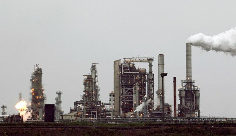 This April 2, 2010 file photo shows a Tesoro Corp. refinery, including a gas flare flame that is part of normal plant operations, in Anacortes, Wash. 