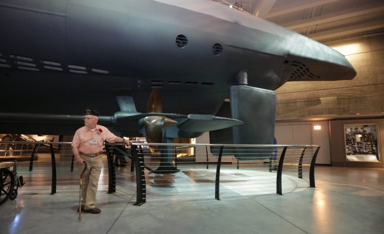 World War II veteran Doug Thrutchley stands by the captured U-505 German submarine on display at the Museum of Science and Industry in Chicago, Wednesday, June 4, 2014. Thrutchley, who was involved with capture of the 252-foot vessel, was on hand to mark the 70th anniversary of its capture. It is the only German submarine the U.S. Navy captured during the war and one of five left in the world. (AP Photo/Stacy Thacker)